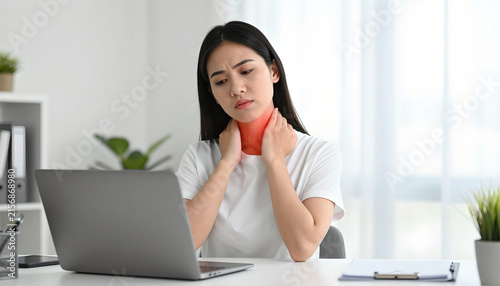 Female Worker Experiencing Neck Pain in Home Office: Health Awareness