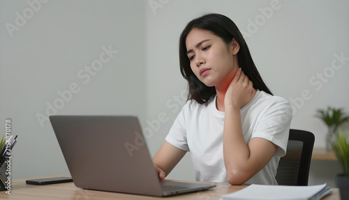 Young Woman Experiencing Neck Pain While Working: Remote Work Health