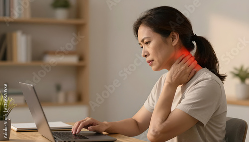 Mature Woman Experiencing Neck Pain at Home Office: Wellness Focus