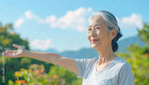 Senior woman outdoors smiling open arm garden sky mountain sunlight