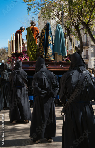 Quadro su tela A Holy Week procession in Spain featuring a local religious brotherhood with hooded penitents and a float bearing religious images, which has been designated a site of international tourist interest