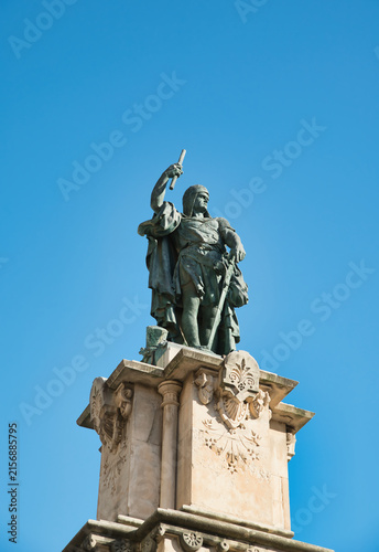 The monument depicted in the image is the statue of Roger de Llúria, the renowned admiral of the Crown of Aragon, located at the end of the Rambla Nova in Tarragona, Spain.