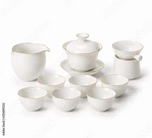 A white ceramic tea set arranged on a clean white surface