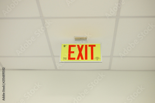 emergency exit sign on tile ceiling