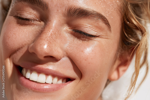 Dewy skin smile close up macro natural freckles woman teeth healthy skin glowing skin