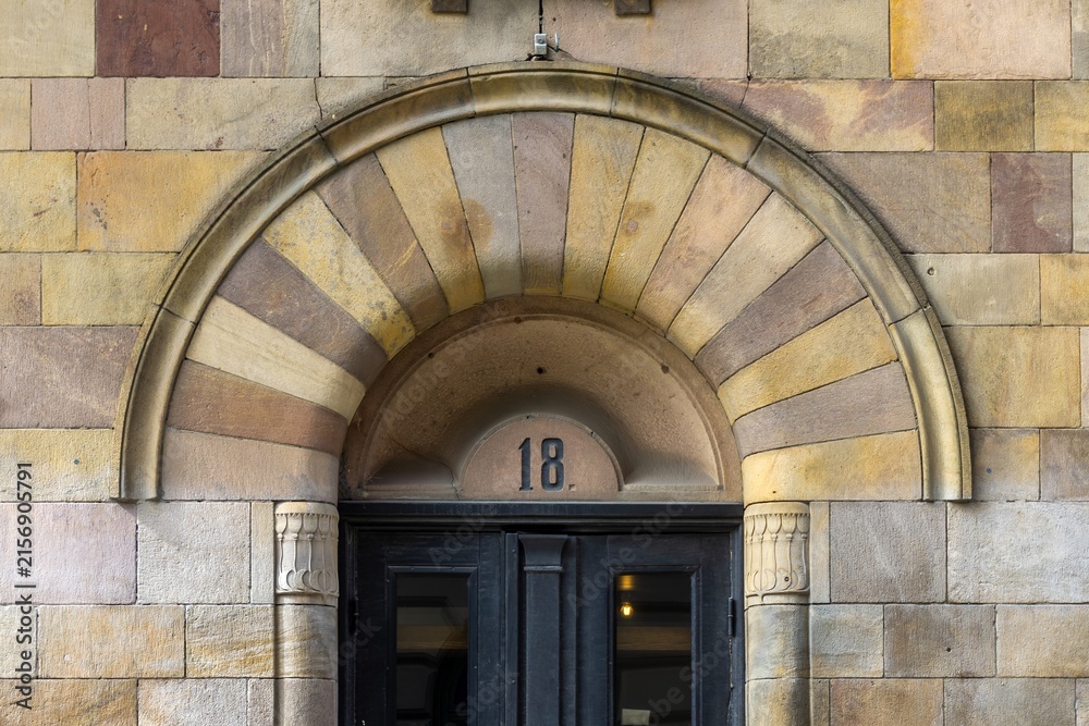Fototapeta premium Stockholm building entrance showing arched stone doorway number 18