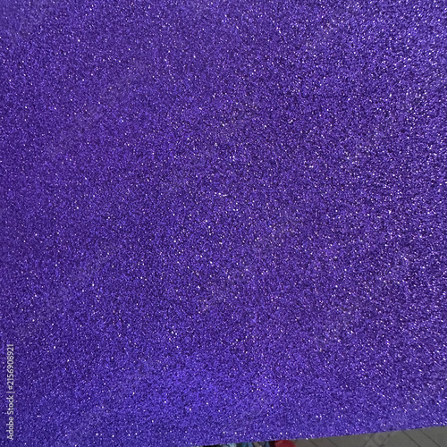 Deep purple glitter texture with sparkling reflective particles