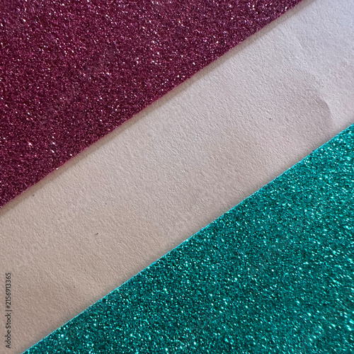Diagonal strips of burgundy and teal glitter paper with beige cardstock