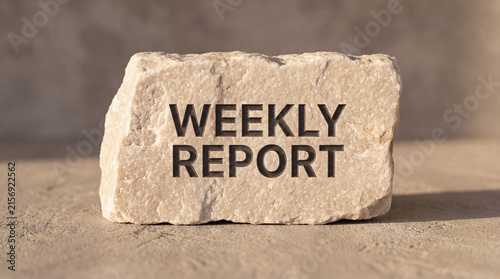 Weekly report carved into stone presenting business updates, stability, and a solid foundation for corporate communication