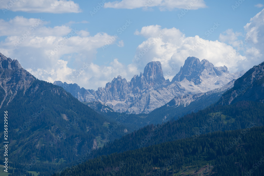 Obraz premium Majestic scenery of rough mountain ridge near grassy hills
