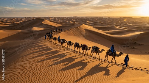 Nomadic camel caravan traversing massive rippling sand dunes in the vast Sahara desert, golden evening sunlight casting long dark shadows.