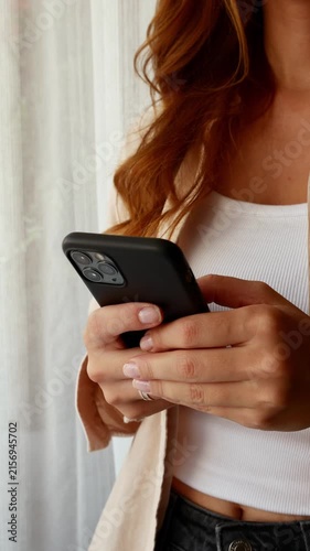 Young woman texting on smartphone for online communication and social media.