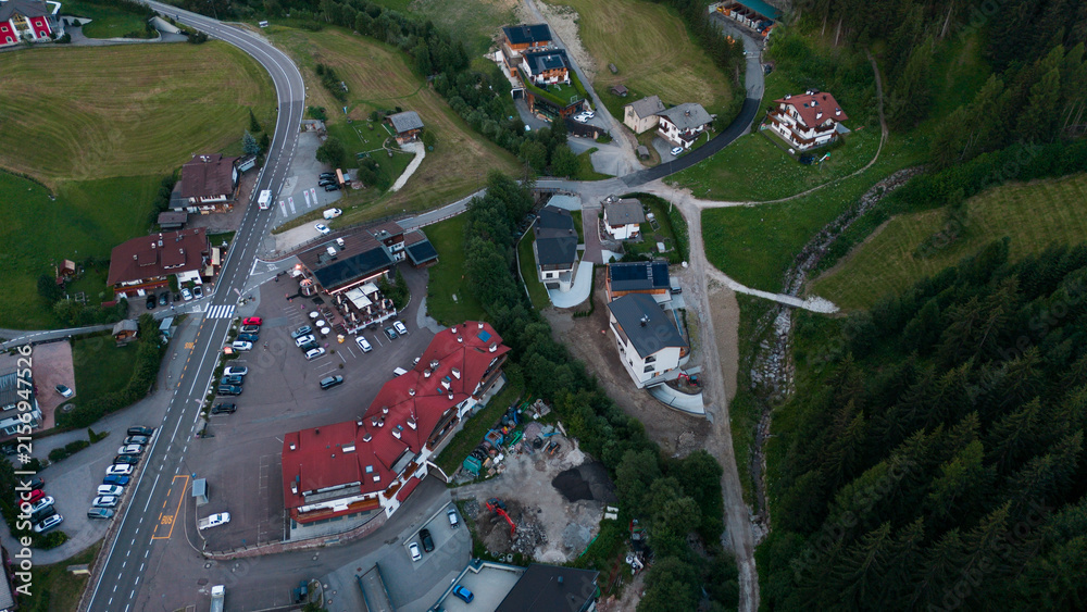 Naklejka premium Aerial view of rural road, road junction in a mountain village