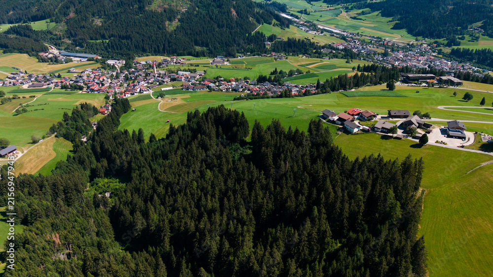 Obraz premium Majestic scenery of rough mountain ridge near grassy hills