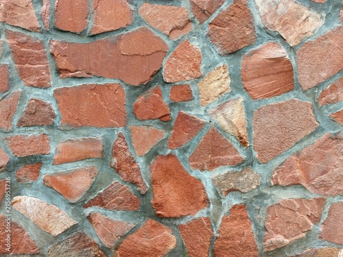 Fotografie Red sandstone wall showing rustic masonry texture and construction pattern