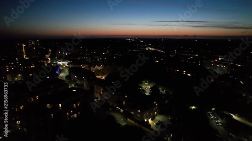 High Angle Night Footage of Illuminated Buildings and Roads with Traffic at Best Tourist Attraction Destination of England at Bournemouth City with Sandy Beach and Ocean of Great Britain, 