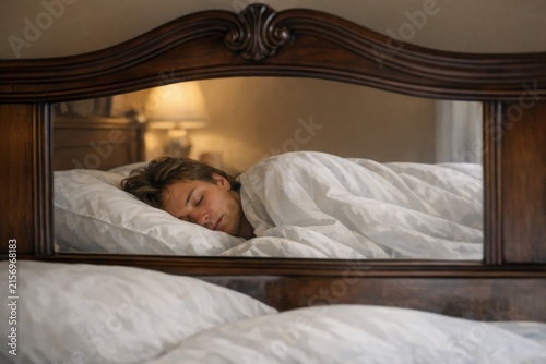 A woman lying on a bed with her eyes closed, possibly resting or recovering from illness