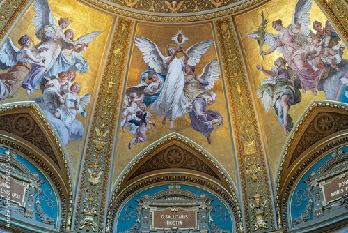Фотография Gilded mosaic of musician and adoring angels above Latin devotional inscriptions