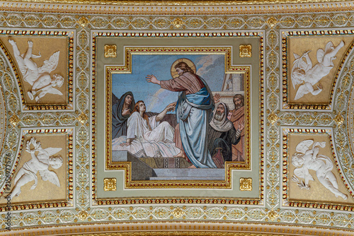 Obraz na plátně Ceiling mosaic panel of a biblical healing scene flanked by cherub reliefs insid