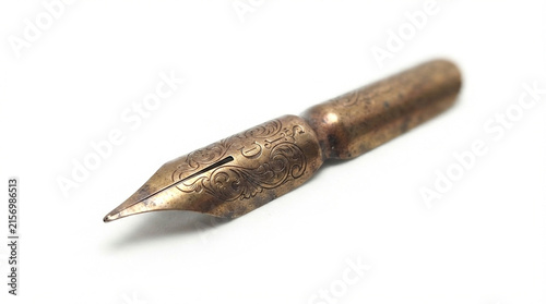 Antique brass fountain pen nib with engraved floral scrollwork, vintage writing point, isolated on white background