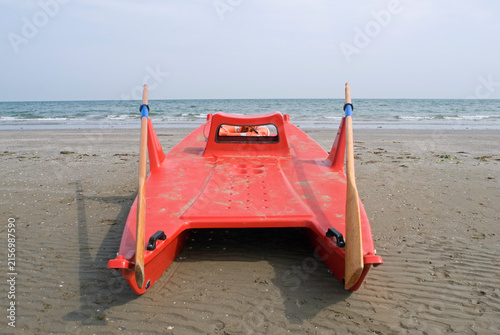 red plastic lifeboat on beach