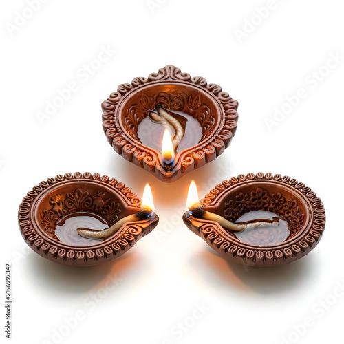 Three traditional clay diya lamps arranged in a triangle