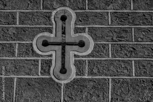 Cross with Rifle Ports on a Rugged Brick Wall .