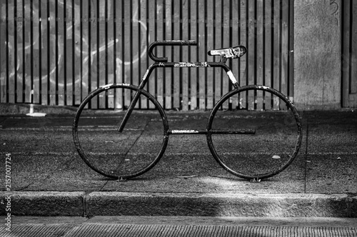 Black Metal Bicycle Stand on a Dirty Street.