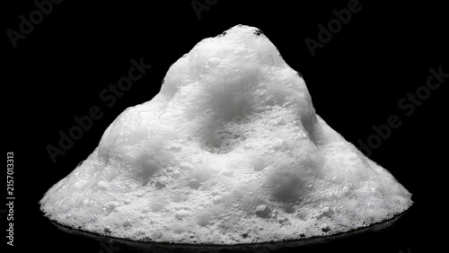 A pile of white soap foam bubbles isolated on a black background