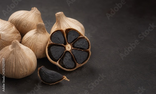 Black Garlic Bulbs and Cross Section with Copy Space