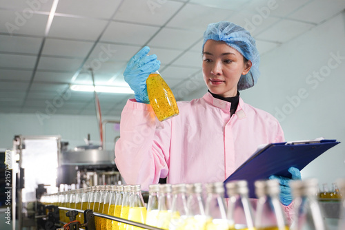 Quality control inspection of liquid food products on an industrial manufacturing line.	