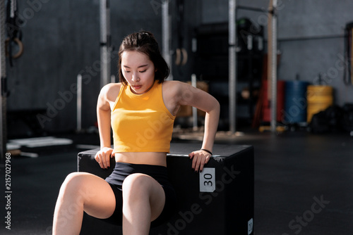 Woman doing triceps dip workout at the gym.