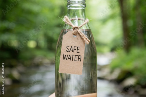 Hand holding a glass bottle with a 