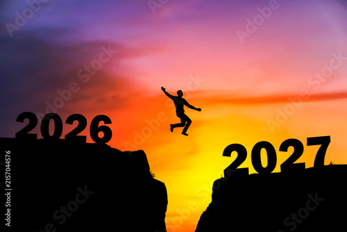 Silhouette Leaping from 2026 to 2027 at Sunset for New Year Success Concept