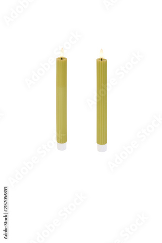 Fotografie Two tall green taper candles with glowing warm light flames standing upright for