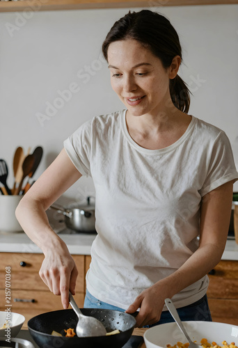 Young woman cooking healthy...