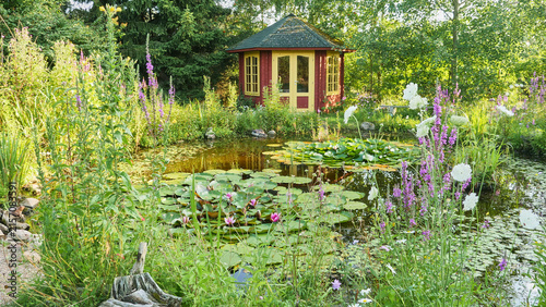 garden with pond and red garden house in an ecologically desirable way 130 
