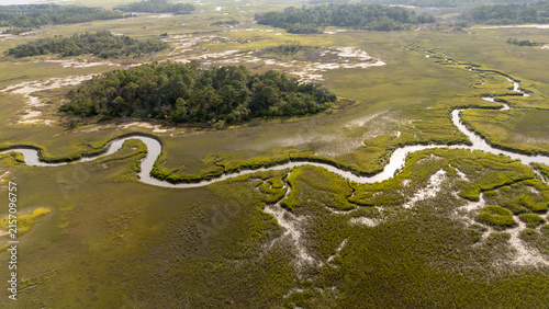 Obraz na plátně Drone view of lowcountry marshland showing winding creek and island during dayli