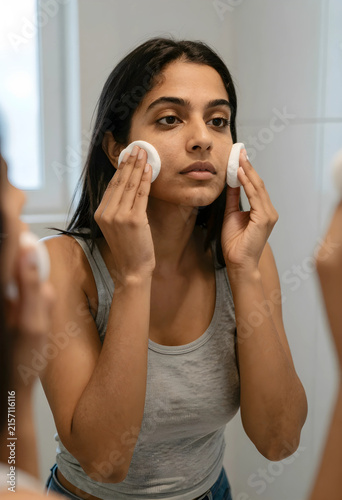 Young indian woman cleansin...