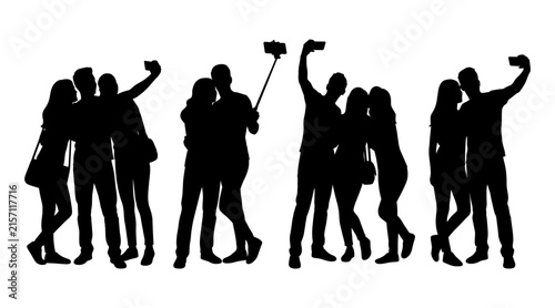Canvastavla Silhouettes of people taking selfies with smartphones and selfie sticks