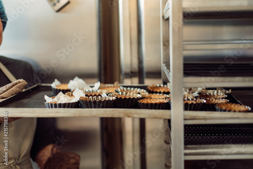 Konstfotografi Freshly baked pastry tartlets on a baking tray