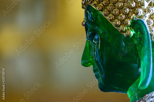 Close-Up Profile of Emerald Buddha Replica with Copy Space at Wat San Pa Yang Luang, Lamphun, Thailand