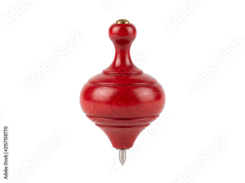 Red wooden spinning top toy with metal tip isolated on transparent background; handcrafted lacquered surface and classic playful form shown upright