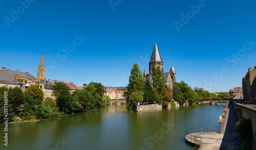 Photography Temple Neuf church standing on an island in the Moselle River on a sunny day