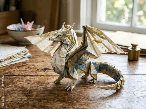 Metal dragon sculpture sitting on a wooden desk
