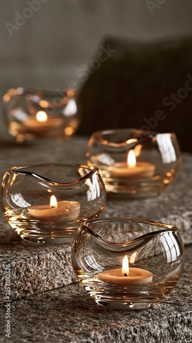 Melted tealight welted beside a dim holder cup with an alloy rim chamfer