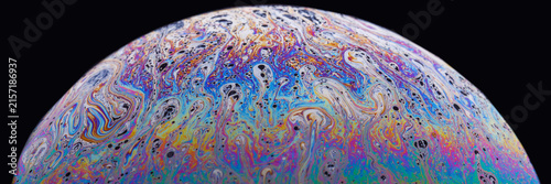 Fotografie Painterly soap bubble surface with vibrant magenta, turquoise and indigo ridges, full of motion and intricate microstructure