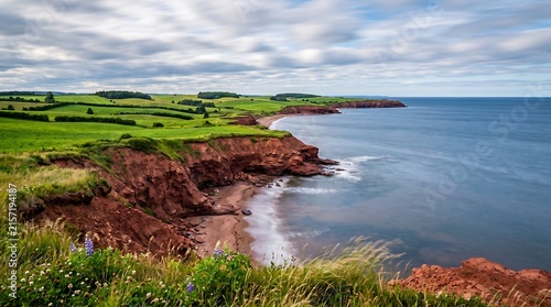 Prince Edward Island red sand cliffs and green farmland meeting blue Gulf of St Lawrence.