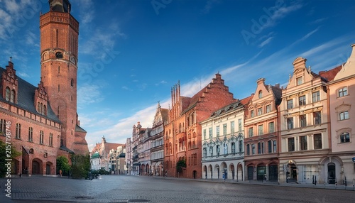 historic european city architecture with brick tower and ornate buildings