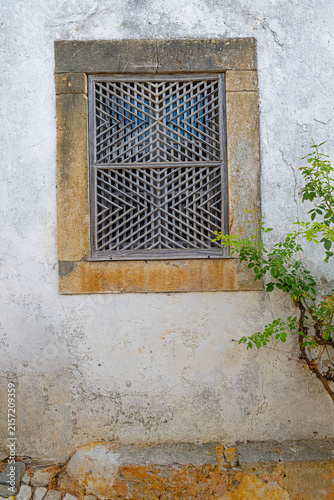 Canvastavla Traditional wooden lattice window detail on an ancient stone wall in the historic village of Obidos, Portugal